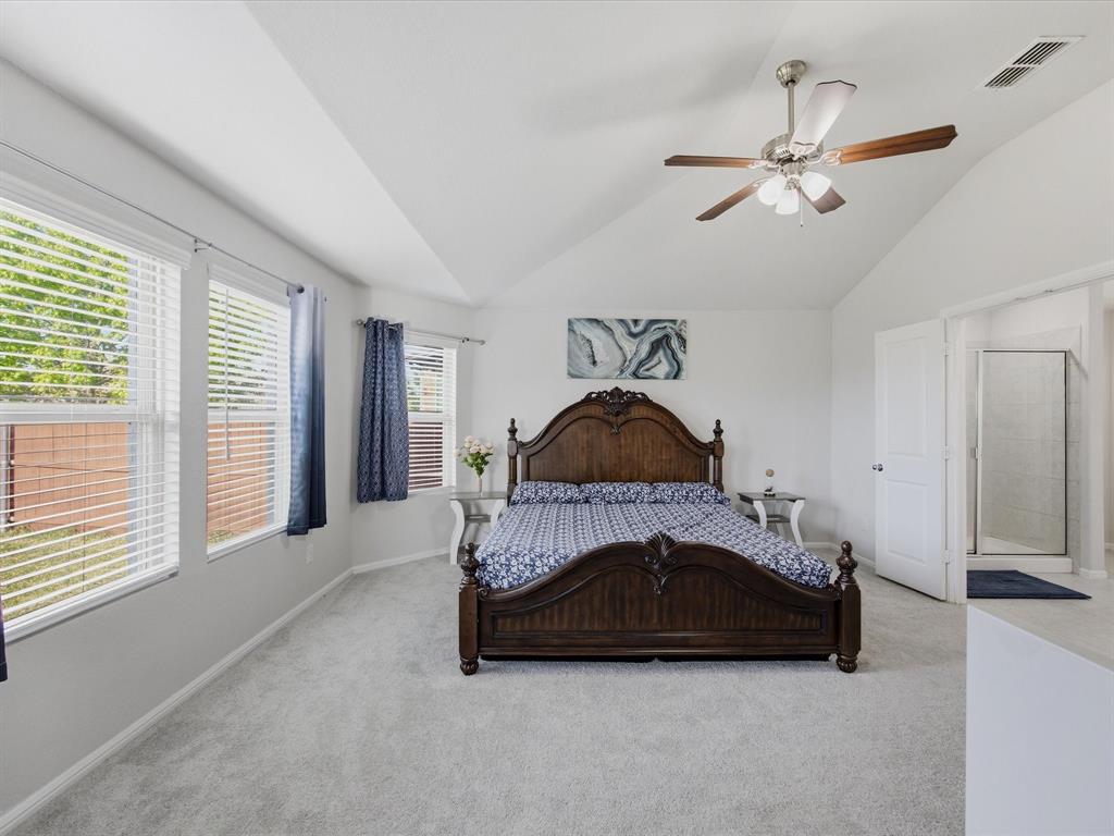 6000 Sutton Fields Trail Aubrey, TX 76227 - Photo 15 of 40 Primary Bedroom with light colored carpet, vaulted ceiling, and a ceiling fan