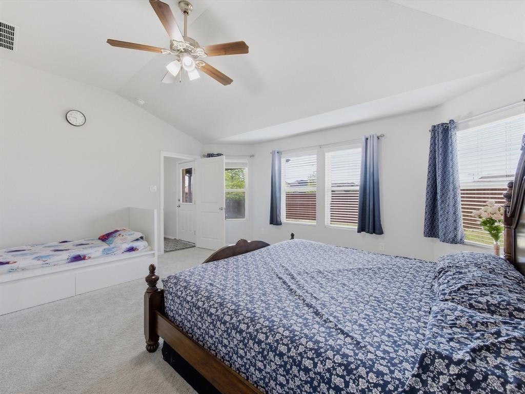 6000 Sutton Fields Trail Aubrey, TX 76227 - Photo 16 of 40 Primary Bedroom with lofted ceiling, light colored carpet, and ceiling fan