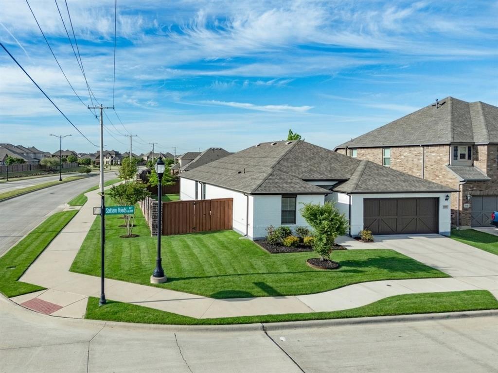 6000 Sutton Fields Trail Aubrey, TX 76227 - Photo 2 of 40 View of front facade featuring roof with shingles, a residential view, a garage, and concrete driveway
