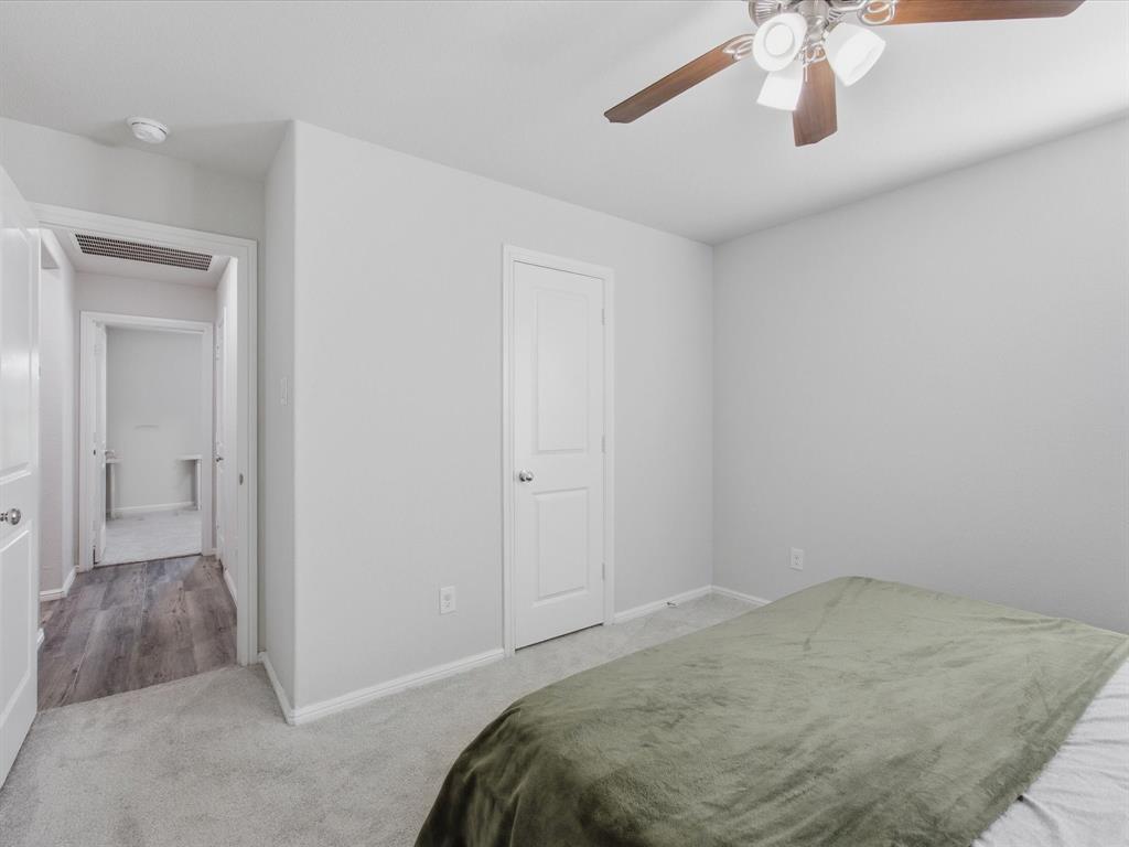 6000 Sutton Fields Trail Aubrey, TX 76227 - Photo 21 of 40 Bedroom with light carpet and a ceiling fan