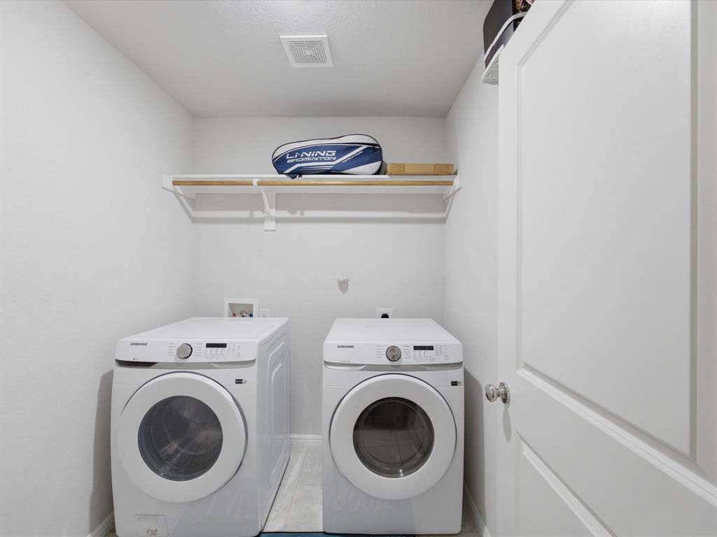 6000 Sutton Fields Trail Aubrey, TX 76227 - Photo 25 of 40 Laundry area featuring washing machine and dryer and light tile patterned floors