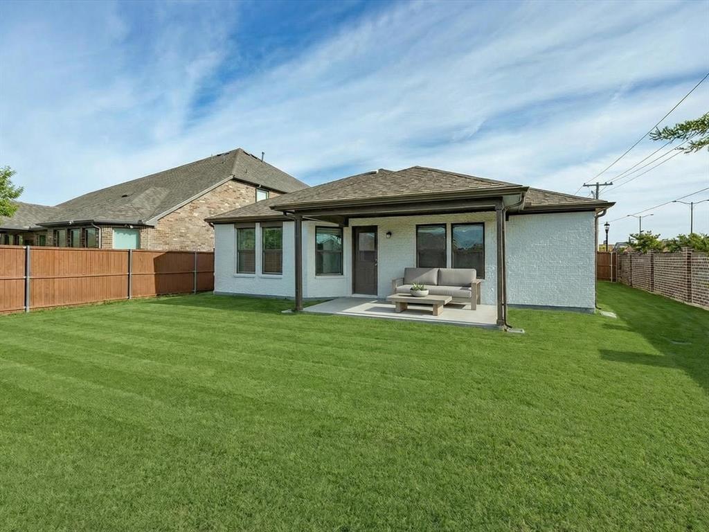 6000 Sutton Fields Trail Aubrey, TX 76227 - Photo 29 of 40 Rear view of property with a patio area, a fenced backyard, an outdoor hangout area, roof with shingles, and brick siding