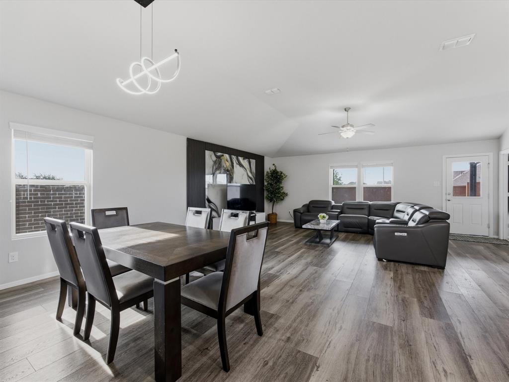 6000 Sutton Fields Trail Aubrey, TX 76227 - Photo 6 of 40 Dining space with a ceiling fan, wood finished floors, and vaulted ceiling