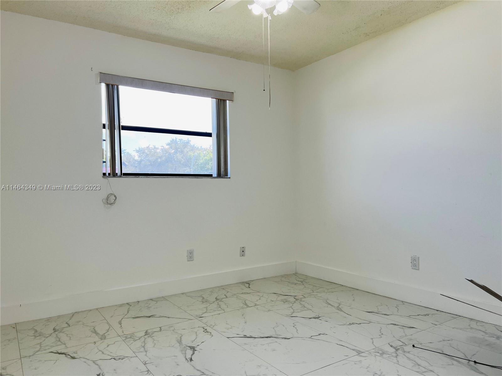 11301 Southwest 203rd Terrace Miami, FL 33189 - Photo 19 of 51 an empty room with a window
