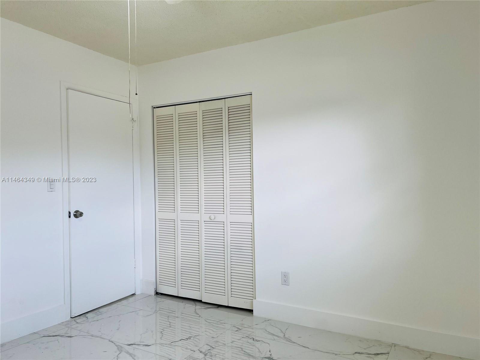 11301 Southwest 203rd Terrace Miami, FL 33189 - Photo 20 of 51 an empty room with windows