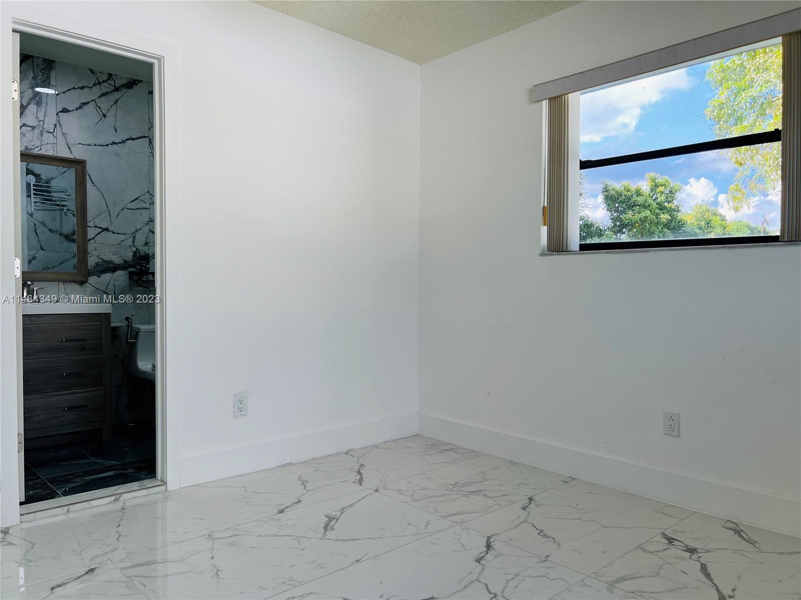 11301 Southwest 203rd Terrace Miami, FL 33189 - Photo 25 of 51 a view of an empty room with a window