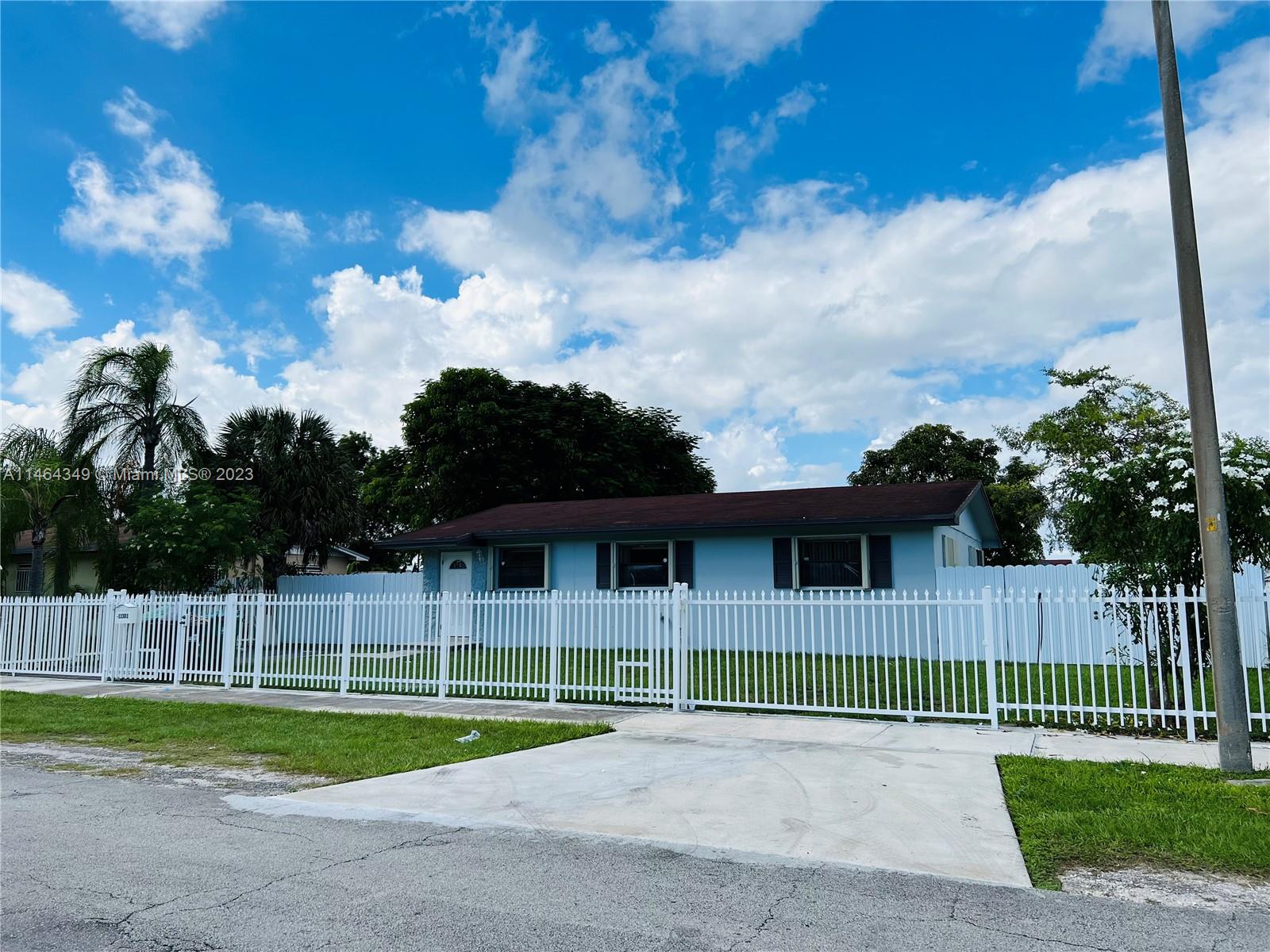 11301 Southwest 203rd Terrace Miami, FL 33189 - Photo 3 of 51 a view of a house with a yard