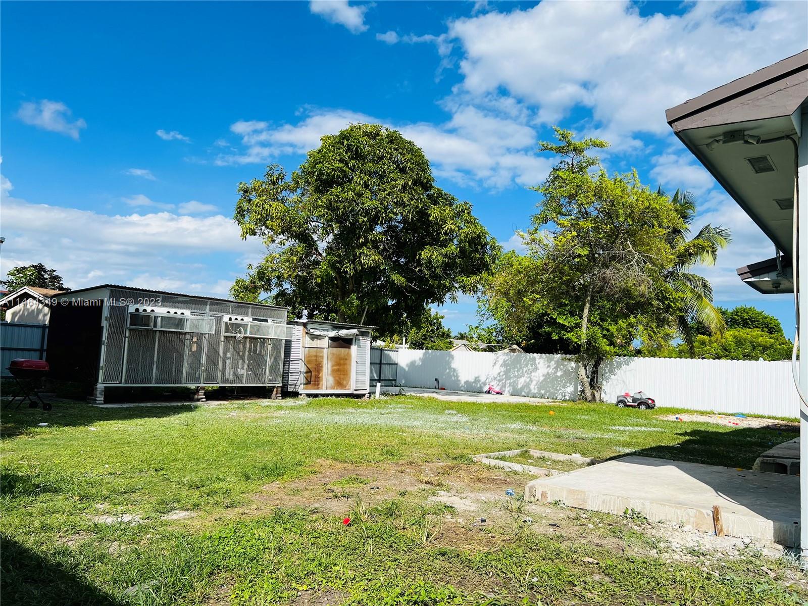 11301 Southwest 203rd Terrace Miami, FL 33189 - Photo 33 of 51 a view of a house with a yard