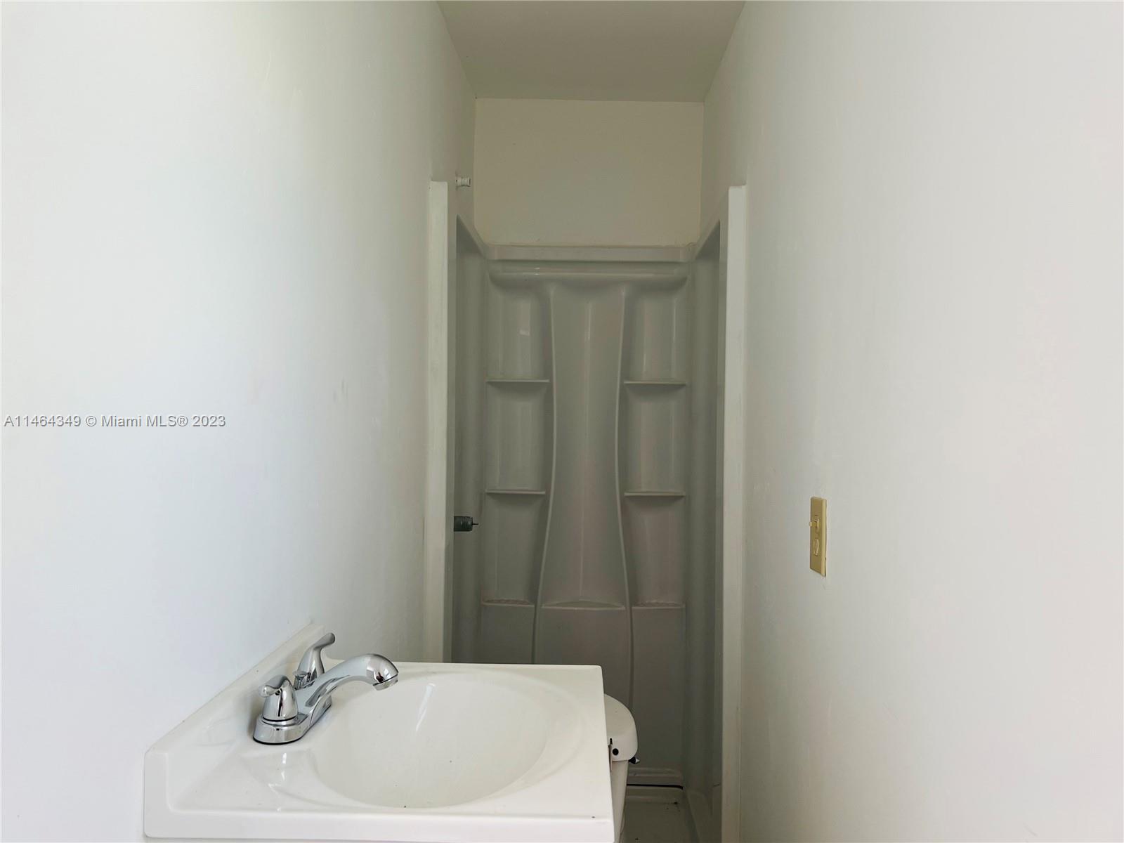 11301 Southwest 203rd Terrace Miami, FL 33189 - Photo 40 of 51 a bathroom with a sink a toilet and shower
