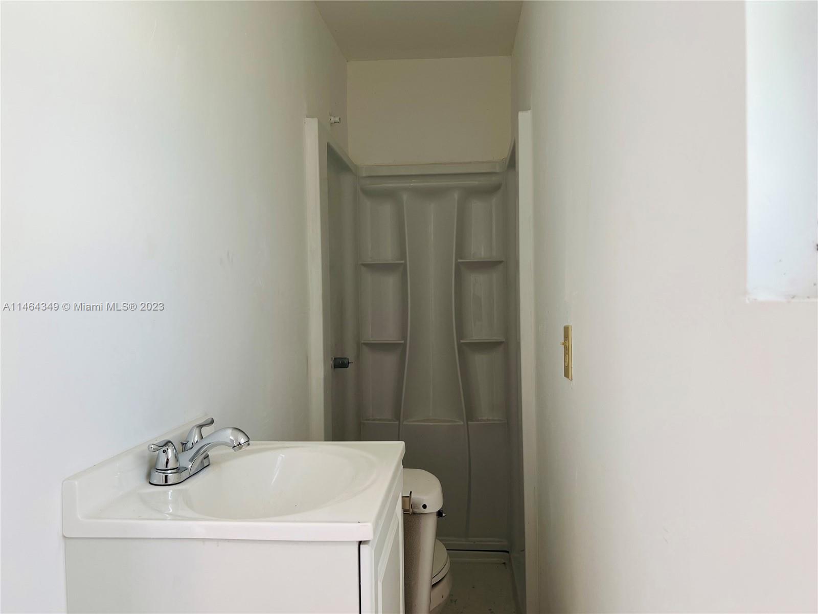 11301 Southwest 203rd Terrace Miami, FL 33189 - Photo 41 of 51 a bathroom with a sink a toilet and shower