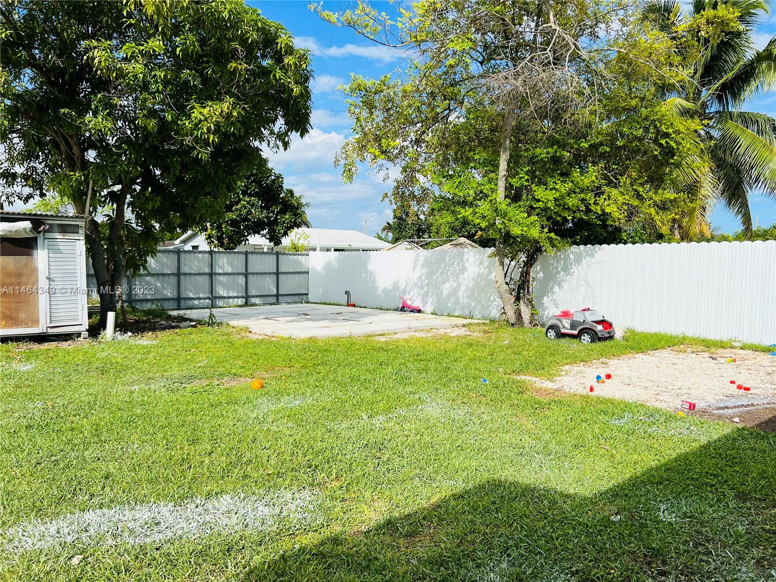 11301 Southwest 203rd Terrace Miami, FL 33189 - Photo 42 of 51 a view of swimming pool with a garden and tree