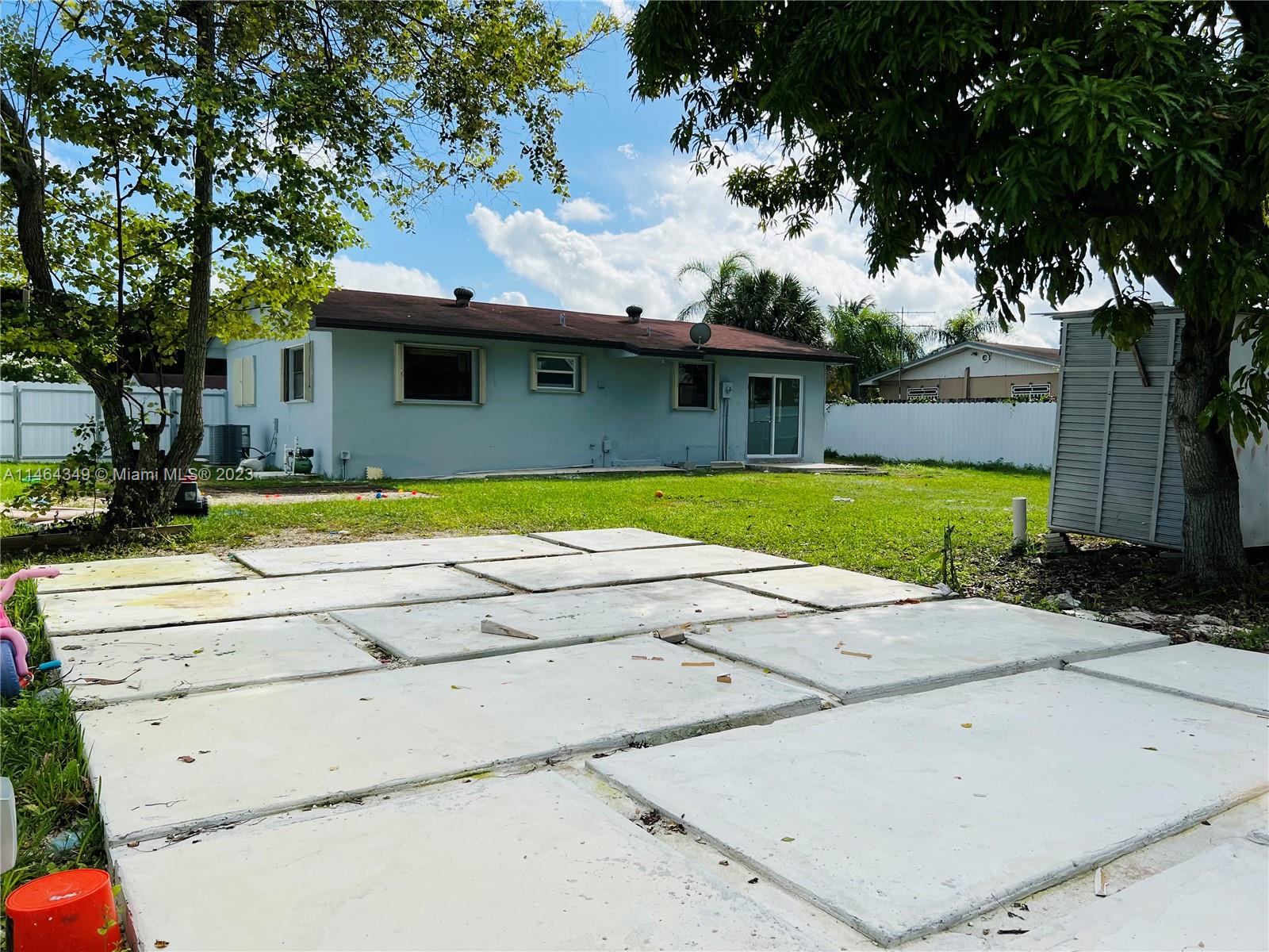 11301 Southwest 203rd Terrace Miami, FL 33189 - Photo 45 of 51 a view of a house with pool and a yard
