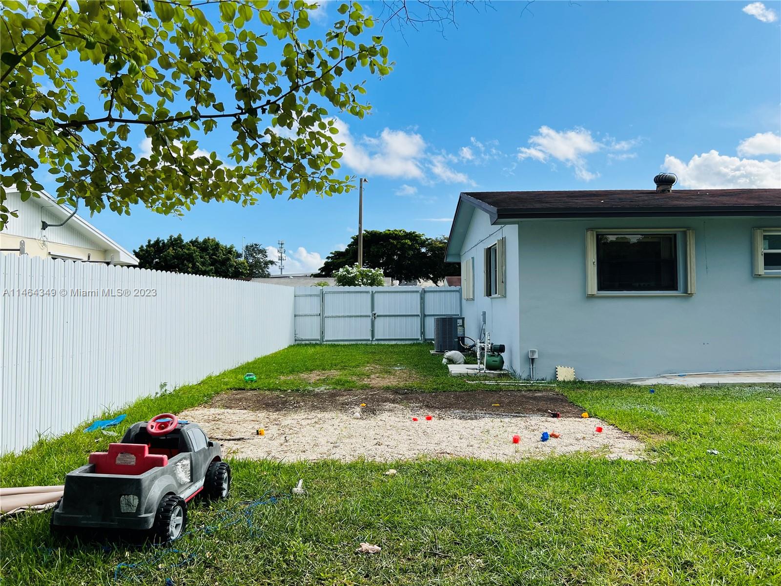11301 Southwest 203rd Terrace Miami, FL 33189 - Photo 47 of 51 a view of a backyard with plants and a garden