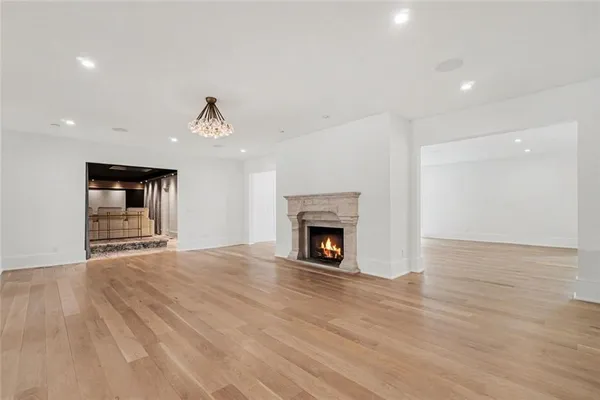 a large kitchen with granite countertop a white stove top oven and white cabinets