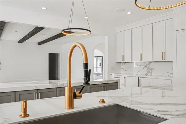 a kitchen with stainless steel appliances granite countertop a stove and a large window