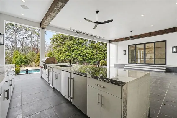 a view of kitchen with stainless steel appliances a refrigerator and cabinets