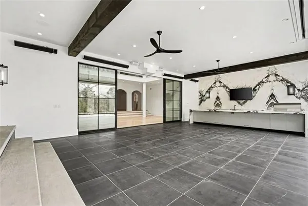 a view of a kitchen with wooden floor and electronic appliances
