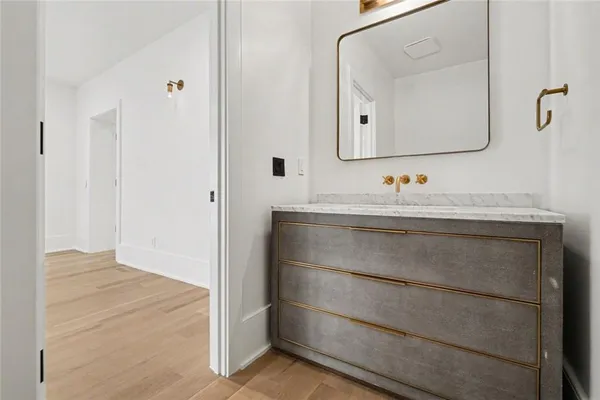 a bathroom with a toilet a sink and a mirror