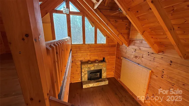 a view of hallway with stairs and wooden floor