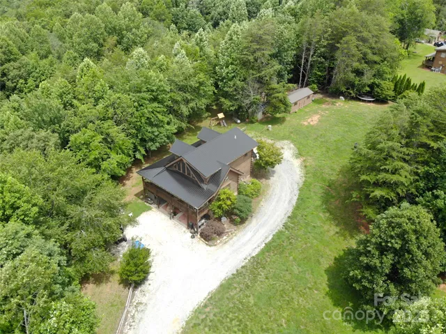 an aerial view of a house with a yard
