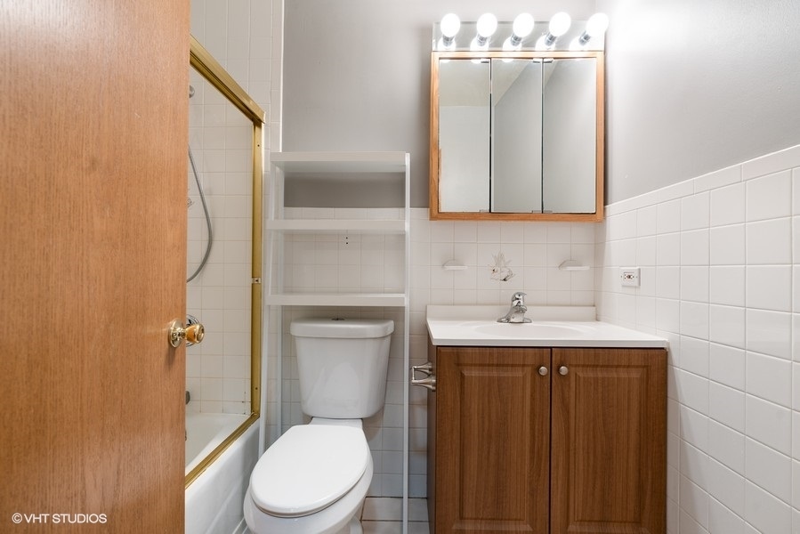 2815 South Farrell Street, Unit A Chicago, IL 60608 - Photo 11 of 18 a bathroom with a toilet a sink and mirror