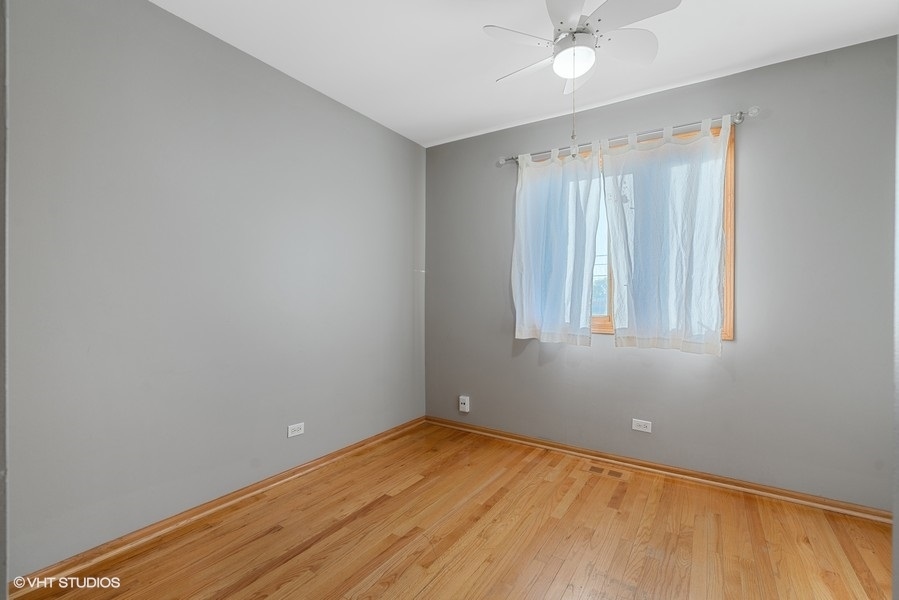 2815 South Farrell Street, Unit A Chicago, IL 60608 - Photo 13 of 18 wooden floor in an empty room with a window