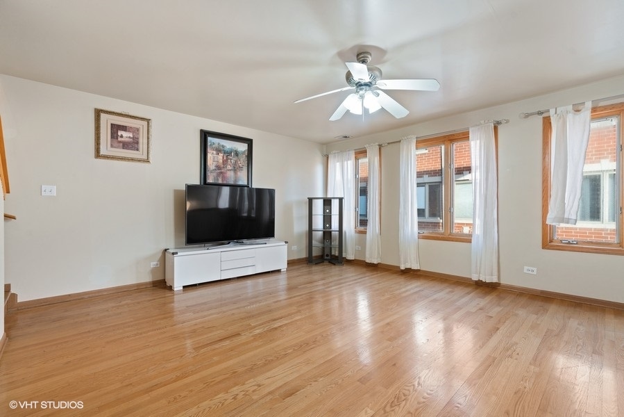 2815 South Farrell Street, Unit A Chicago, IL 60608 - Photo 3 of 18 a view of a livingroom with a ceiling fan window and wooden floor