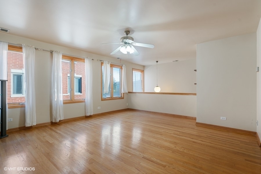 2815 South Farrell Street, Unit A Chicago, IL 60608 - Photo 4 of 18 a view of an empty room with wooden floor and a window