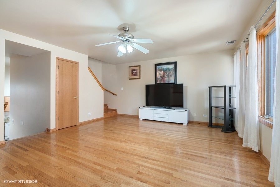 2815 South Farrell Street, Unit A Chicago, IL 60608 - Photo 5 of 18 a view of a livingroom with an empty space and a ceiling fan