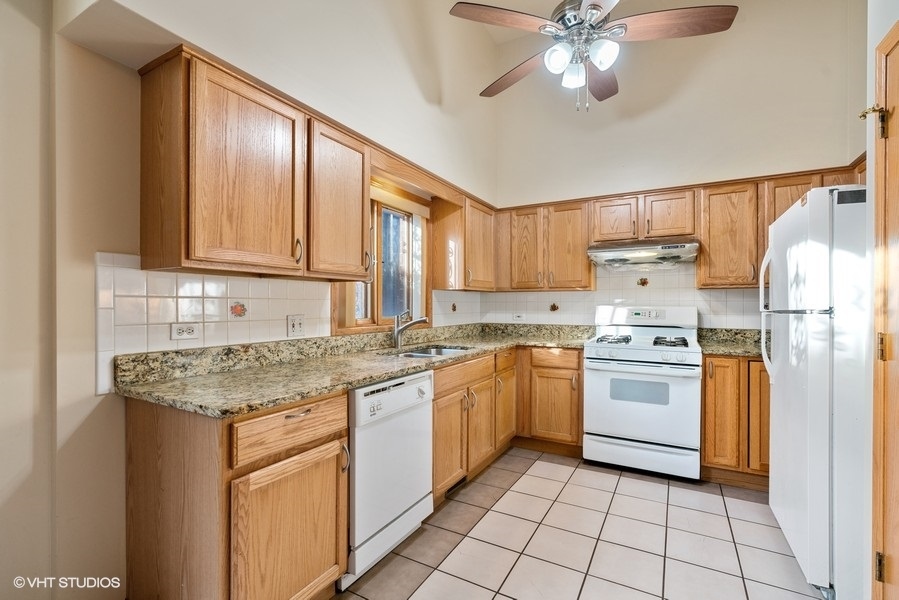 2815 South Farrell Street, Unit A Chicago, IL 60608 - Photo 6 of 18 a kitchen with stainless steel appliances granite countertop a sink stove and refrigerator