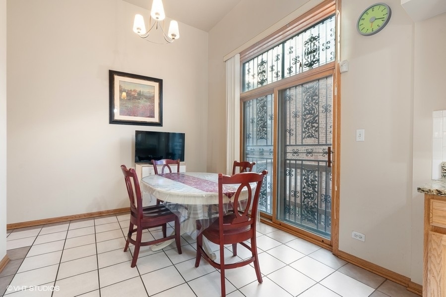 2815 South Farrell Street, Unit A Chicago, IL 60608 - Photo 8 of 18 a view of a dining room with furniture and a window
