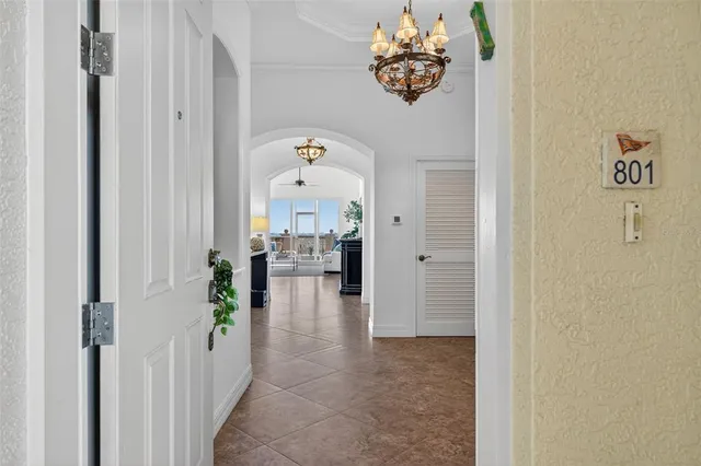 a dining room with furniture a chandelier and wooden floor