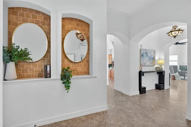 a dining hall with stainless steel appliances kitchen island granite countertop a table and chairs