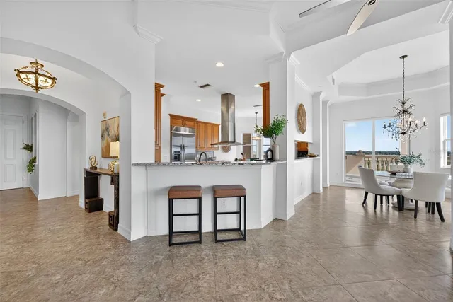 a living room with furniture a table and paintings on the wall