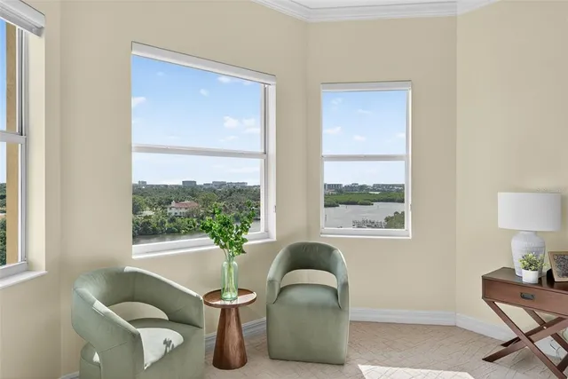 a view of a house with floor to ceiling windows and a patio