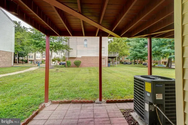 a view of a backyard with table and chairs under an umbrella with a big yard