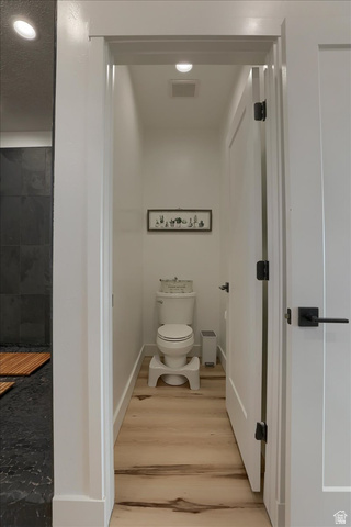 828 South Deer Road Tooele, UT 84074 - Photo 49 of 51 Private water closet featuring light wood-finish flooring, white baseboards, and a recessed ceiling light