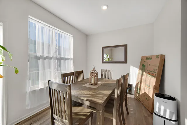 a view of a dining room with furniture and a window