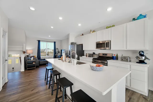 a kitchen with a sink a stove cabinets and counter space