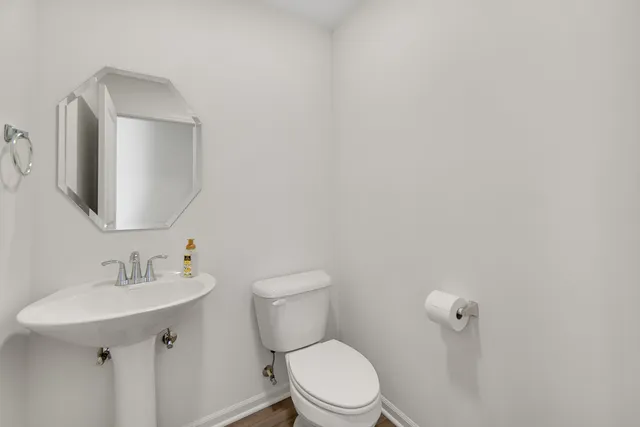 a white toilet sitting next to a bathroom sink