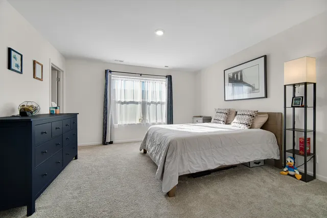 a spacious bedroom with a bed and a window