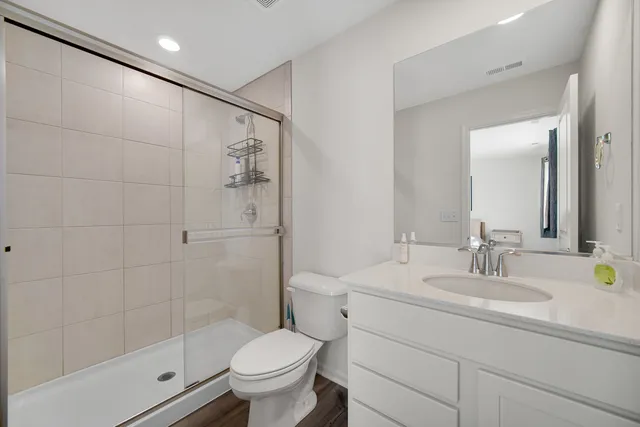 a bathroom with a sink toilet and shower