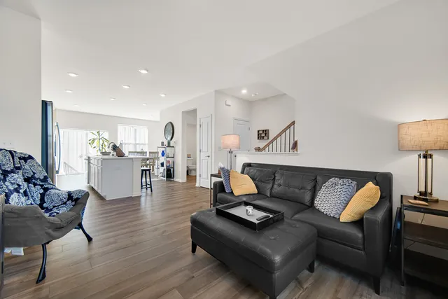a living room with furniture and wooden floor