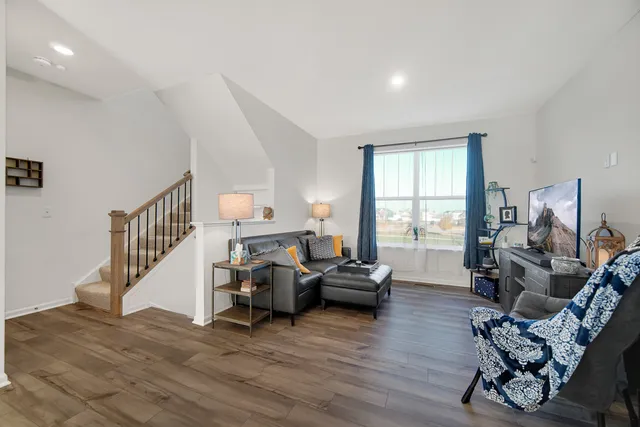 a living room with furniture window and wooden floor