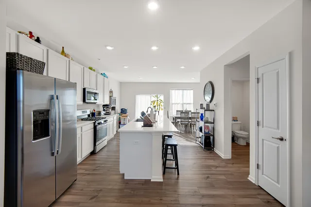 a view of a kitchen and refrigerator in a kitchen