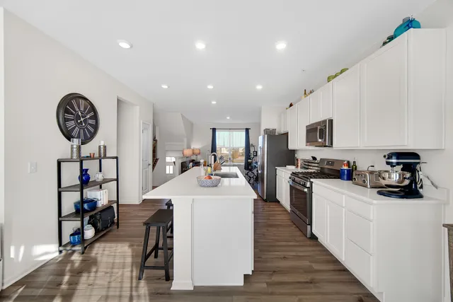a kitchen with a sink appliances and cabinets