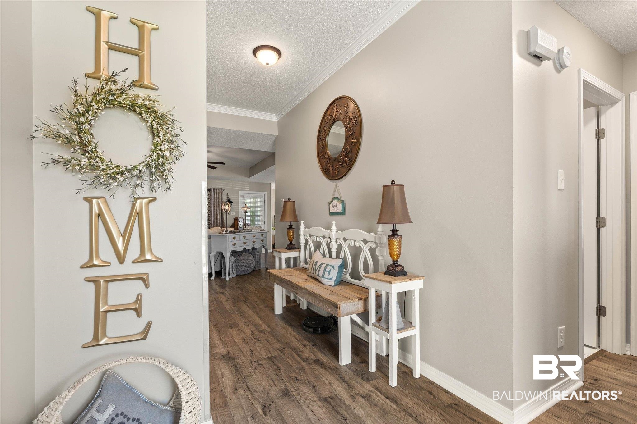 8600 Sable Court Semmes, AL 36575 - Photo 2 of 20 Entrance foyer with wood finished floors, crown molding, and a textured ceiling