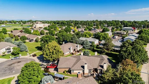 an aerial view of residential houses with outdoor space and trees