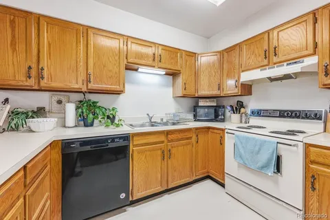 a kitchen with sink and cabinets