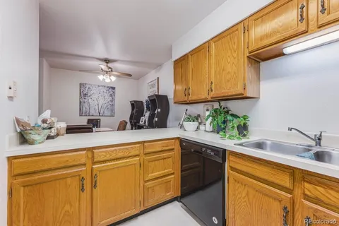 a kitchen with a refrigerator a stove a sink and a cabinets